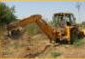 Backhoe digging a utility trench